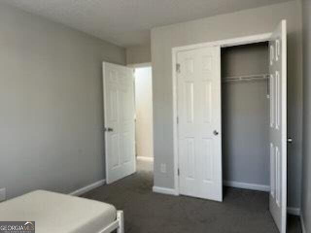 carpeted bedroom featuring a closet