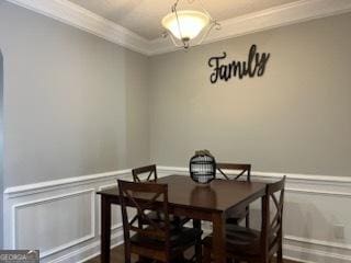 dining space with crown molding