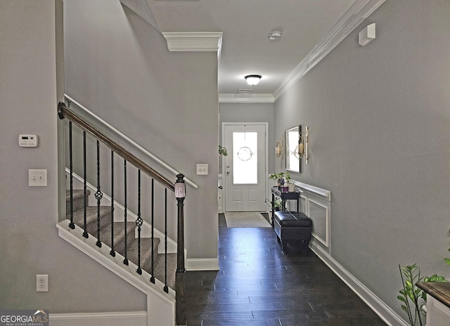 entrance foyer with dark wood-type flooring and crown molding