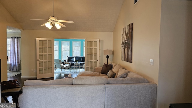 living room featuring ceiling fan, french doors, and vaulted ceiling