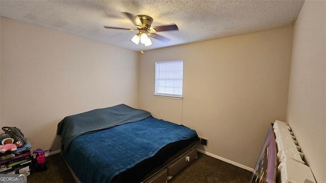 carpeted bedroom featuring ceiling fan and a textured ceiling