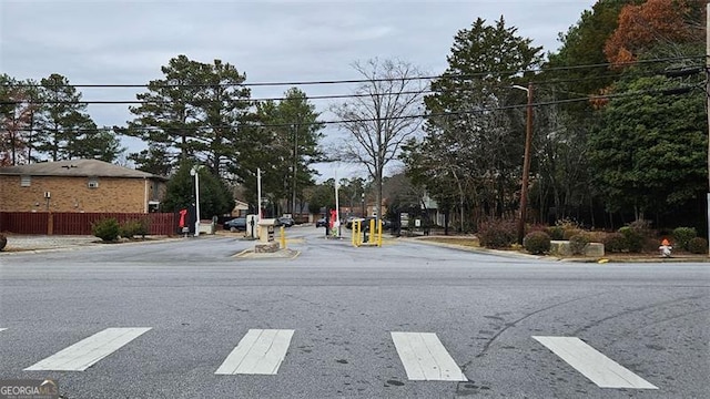 view of street with street lights and curbs