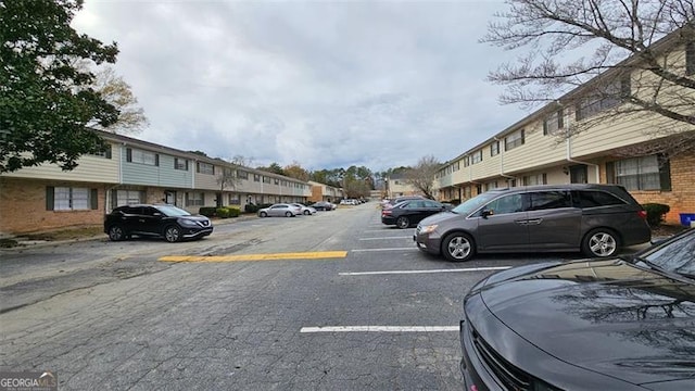 uncovered parking lot with a residential view