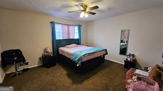 carpeted bedroom featuring ceiling fan and a textured ceiling