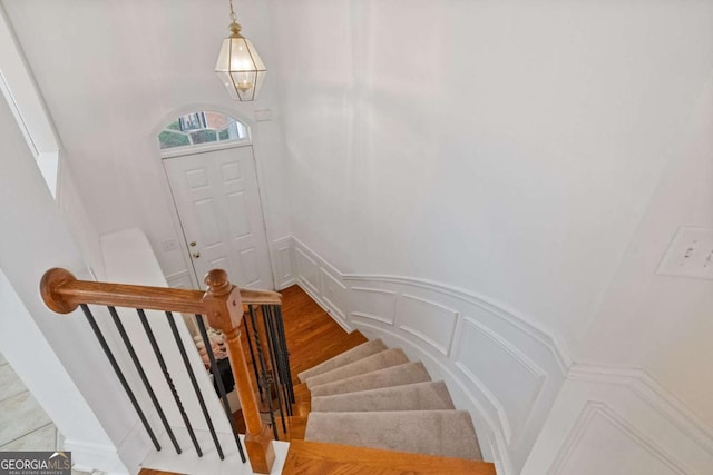 staircase with hardwood / wood-style floors