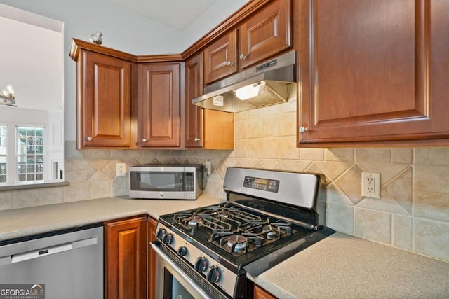 kitchen featuring appliances with stainless steel finishes and tasteful backsplash