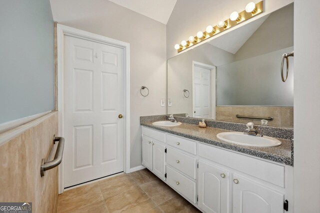 bathroom featuring lofted ceiling and vanity