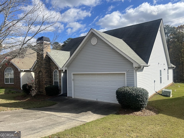 view of property exterior featuring a lawn, cooling unit, and a garage