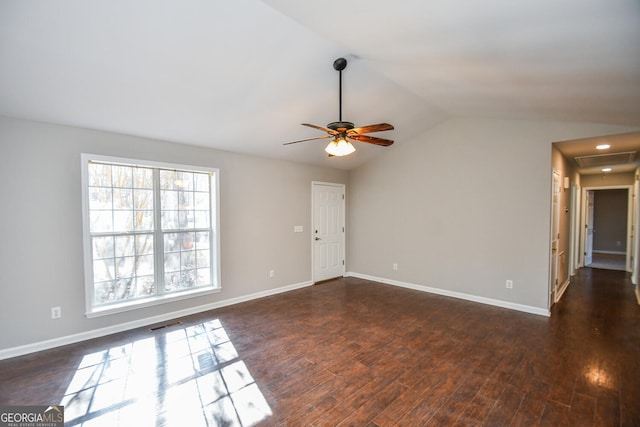 spare room with vaulted ceiling, ceiling fan, and dark hardwood / wood-style floors