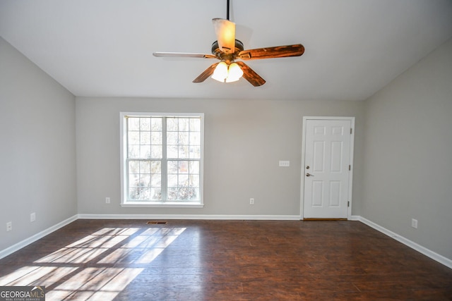 empty room featuring ceiling fan and dark hardwood / wood-style flooring