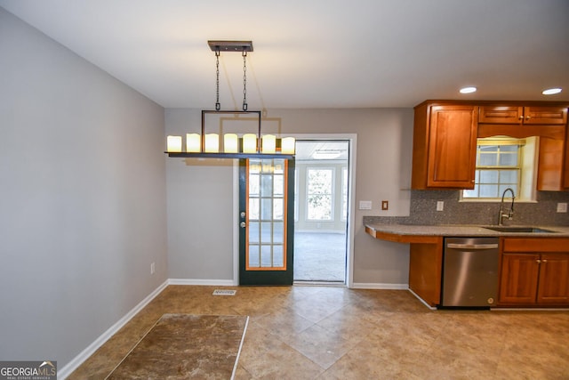 kitchen featuring hanging light fixtures, backsplash, dishwasher, and sink