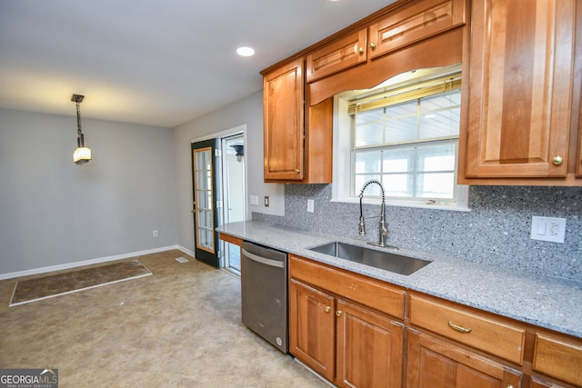 kitchen with decorative light fixtures, dishwasher, sink, french doors, and light stone counters