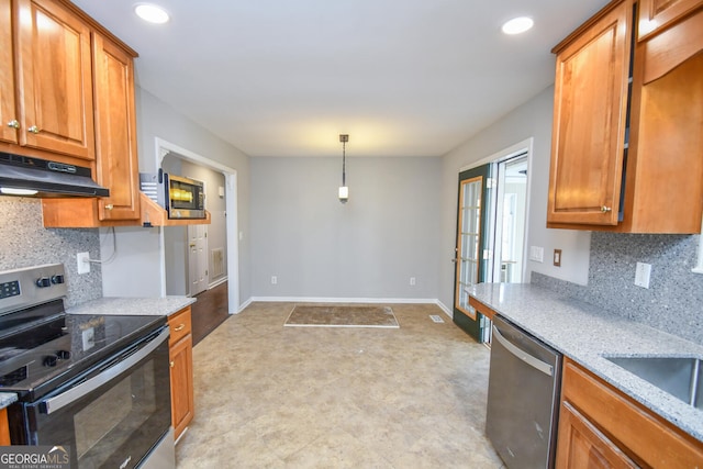 kitchen with stainless steel appliances, pendant lighting, backsplash, and light stone countertops