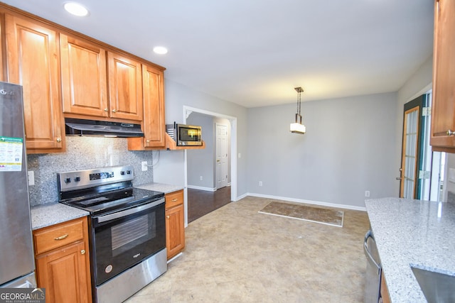 kitchen with decorative light fixtures, light stone countertops, appliances with stainless steel finishes, and decorative backsplash