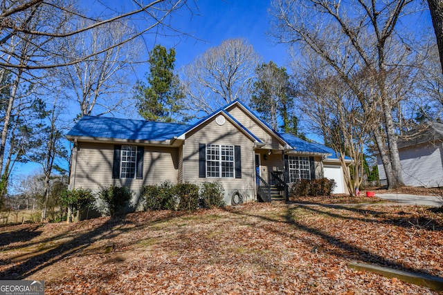 ranch-style home featuring a garage