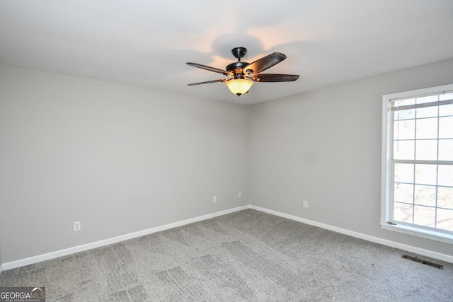 empty room featuring ceiling fan and carpet floors