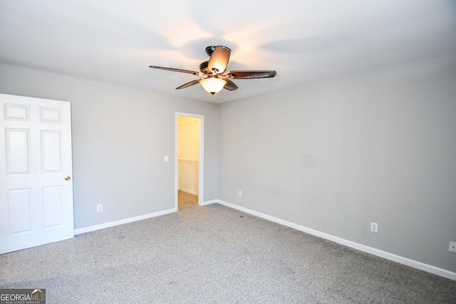 carpeted empty room featuring ceiling fan