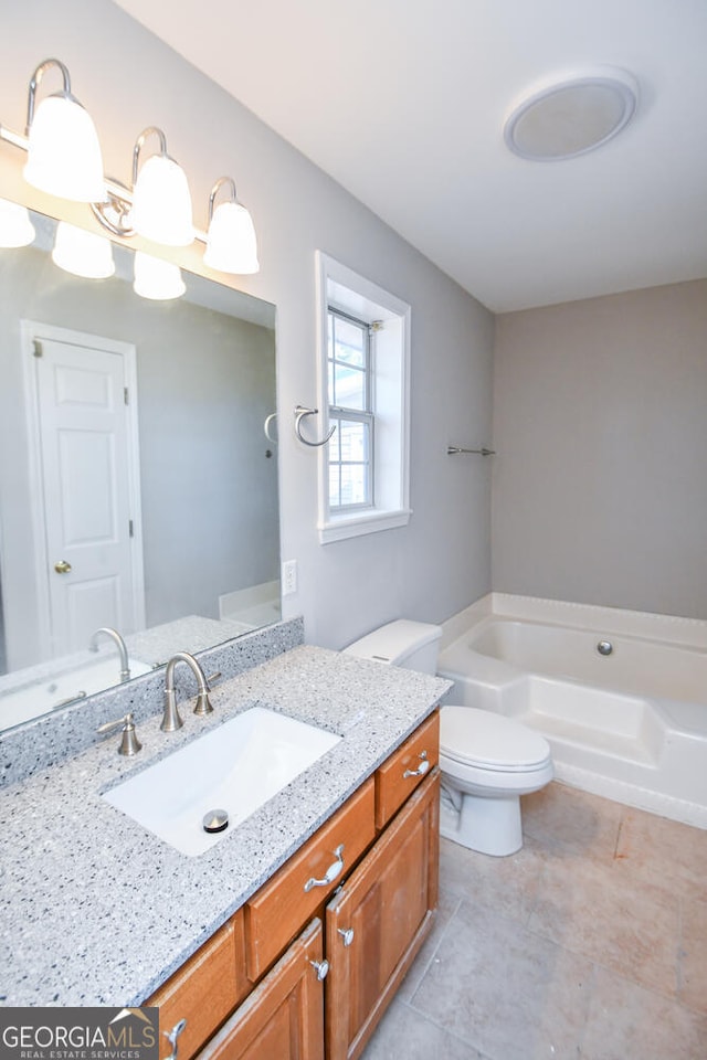 bathroom with a bath, toilet, and vanity