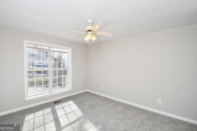 unfurnished room with ceiling fan and carpet flooring