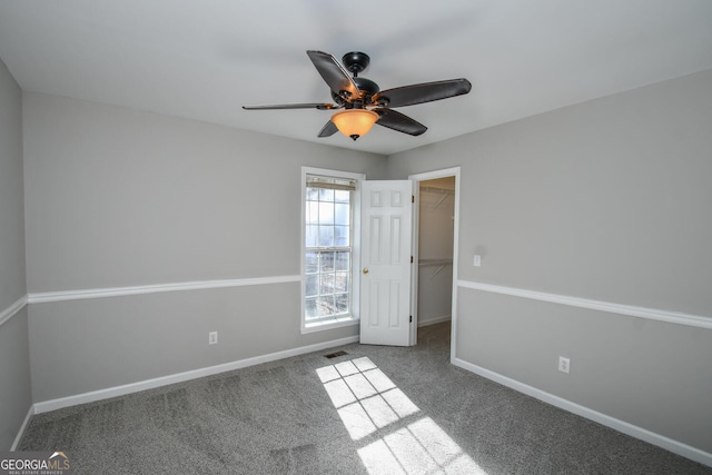 carpeted empty room with ceiling fan