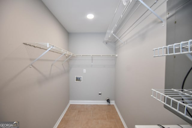 laundry area with light tile patterned floors, washer hookup, and electric dryer hookup