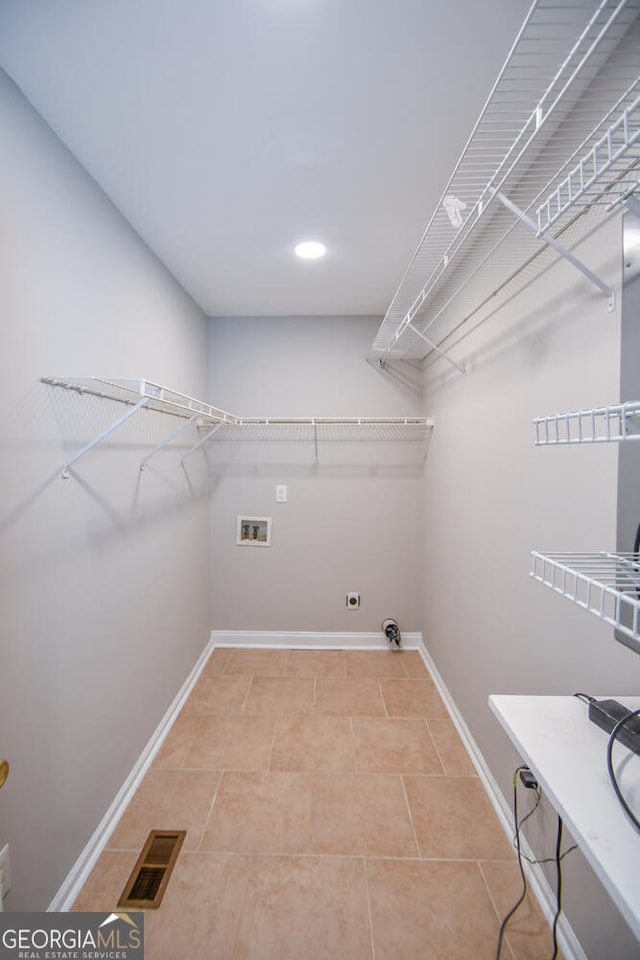 washroom featuring light tile patterned flooring and hookup for a washing machine