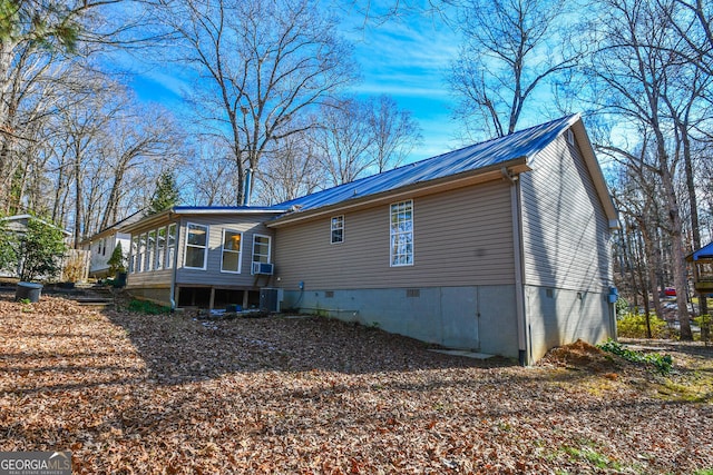 view of property exterior featuring a sunroom