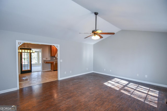 unfurnished living room featuring ceiling fan, lofted ceiling, and dark hardwood / wood-style floors