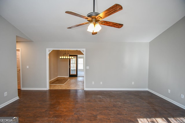 unfurnished room featuring ceiling fan, vaulted ceiling, and dark hardwood / wood-style floors