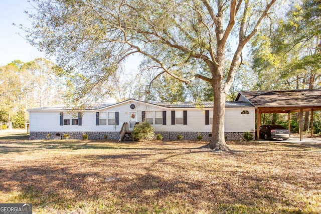 view of front facade with a front yard and a carport