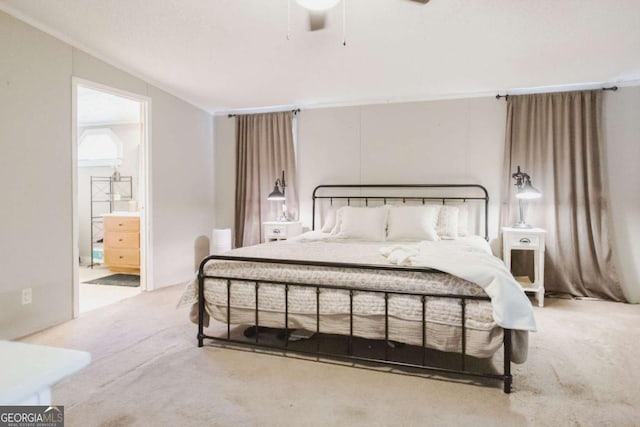 carpeted bedroom featuring ensuite bath, ceiling fan, and lofted ceiling