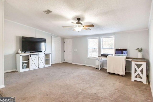 office area with vaulted ceiling, ceiling fan, a textured ceiling, and light colored carpet