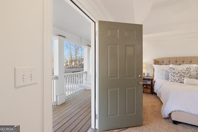 bedroom with access to outside and light carpet