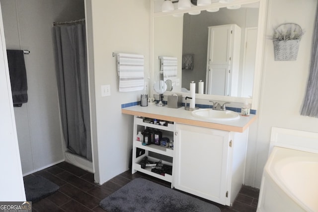 bathroom featuring curtained shower and vanity