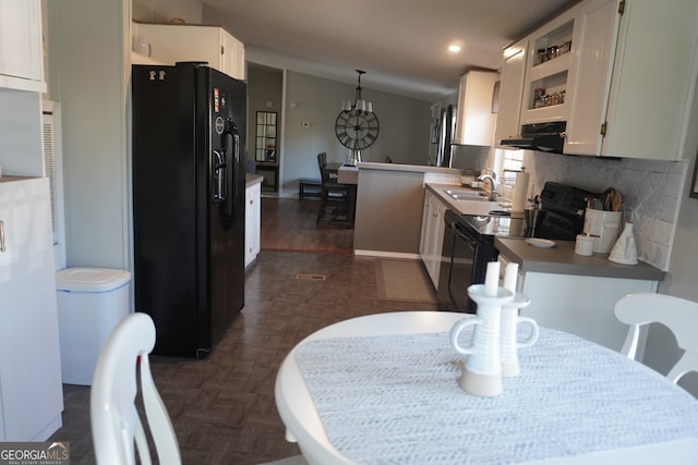 kitchen featuring black appliances, white cabinets, backsplash, and kitchen peninsula