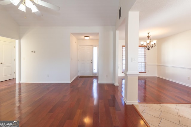 entrance foyer with ceiling fan with notable chandelier and dark wood-type flooring