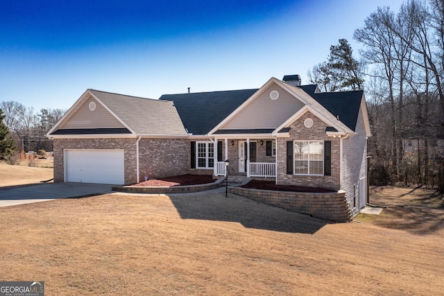 view of front of property featuring concrete driveway, a porch, an attached garage, a front lawn, and brick siding