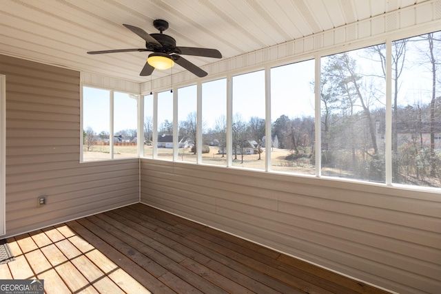 unfurnished sunroom featuring ceiling fan