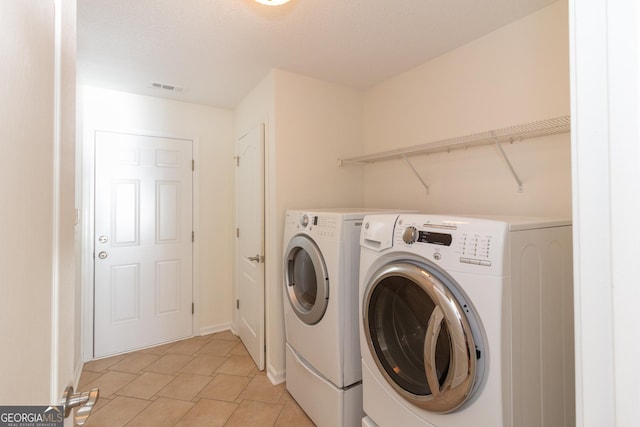 clothes washing area with washer and dryer