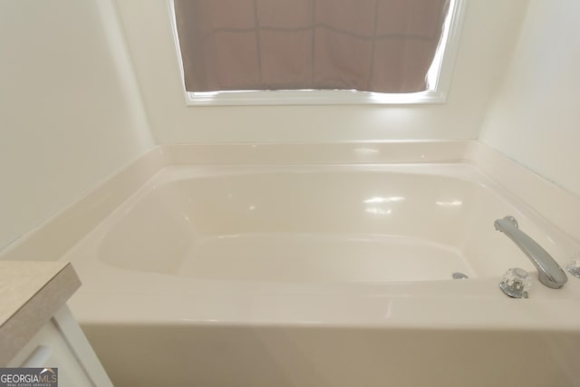 bathroom with a tub to relax in