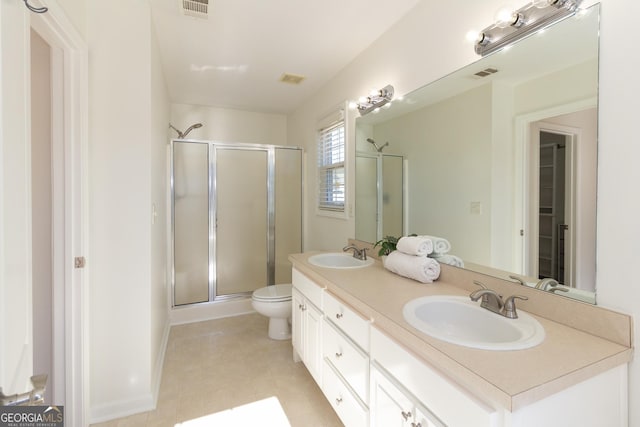 bathroom with vanity, toilet, and a shower with shower door