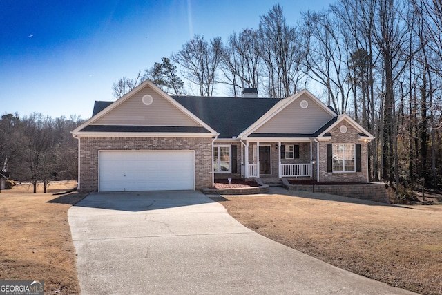 ranch-style house featuring a porch, a garage, and a front lawn