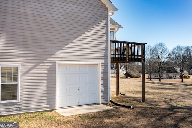 view of side of property featuring a garage and a wooden deck