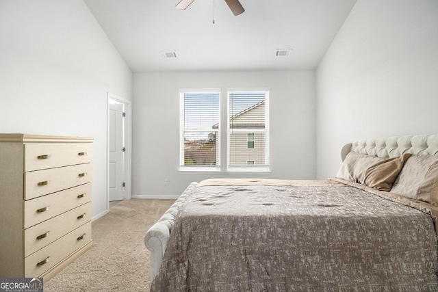 carpeted bedroom featuring ceiling fan and vaulted ceiling