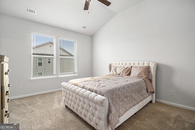 carpeted bedroom with ceiling fan and vaulted ceiling