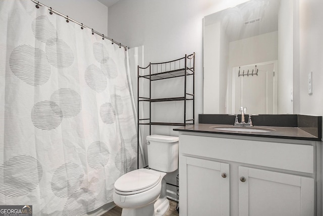 bathroom with toilet and vanity