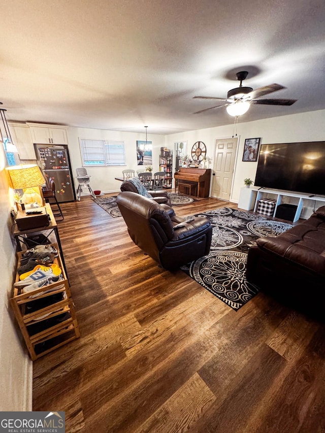 living room featuring hardwood / wood-style floors, a textured ceiling, and ceiling fan