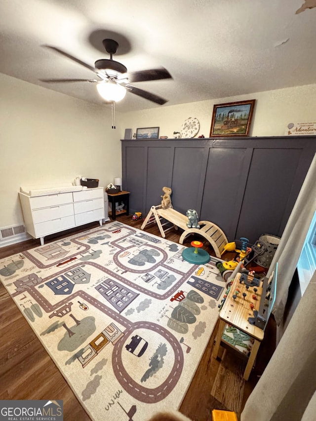 bedroom with dark wood-type flooring and ceiling fan