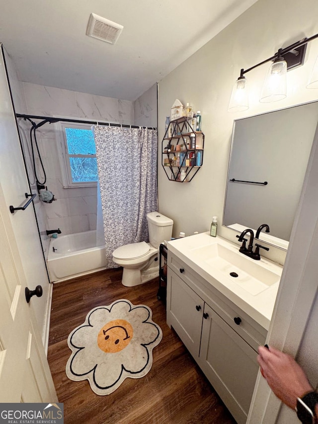 full bathroom with vanity, wood-type flooring, toilet, and shower / bath combo