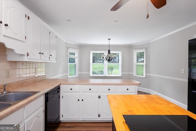 kitchen featuring backsplash, black appliances, hanging light fixtures, white cabinets, and ceiling fan with notable chandelier